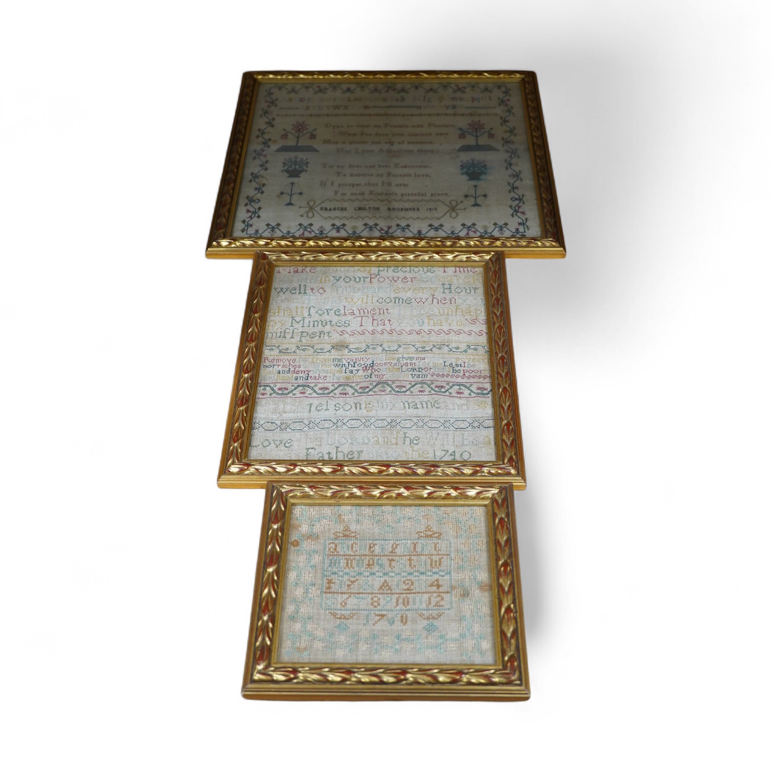 Three framed and glazed samplers, including a 1740 banded sampler by Mary Jelson, 20.5cm x 24cm, embroidered with three various verses, together with a later, smaller, alphabet sampler dated 1760, 15cm x 14cm and another